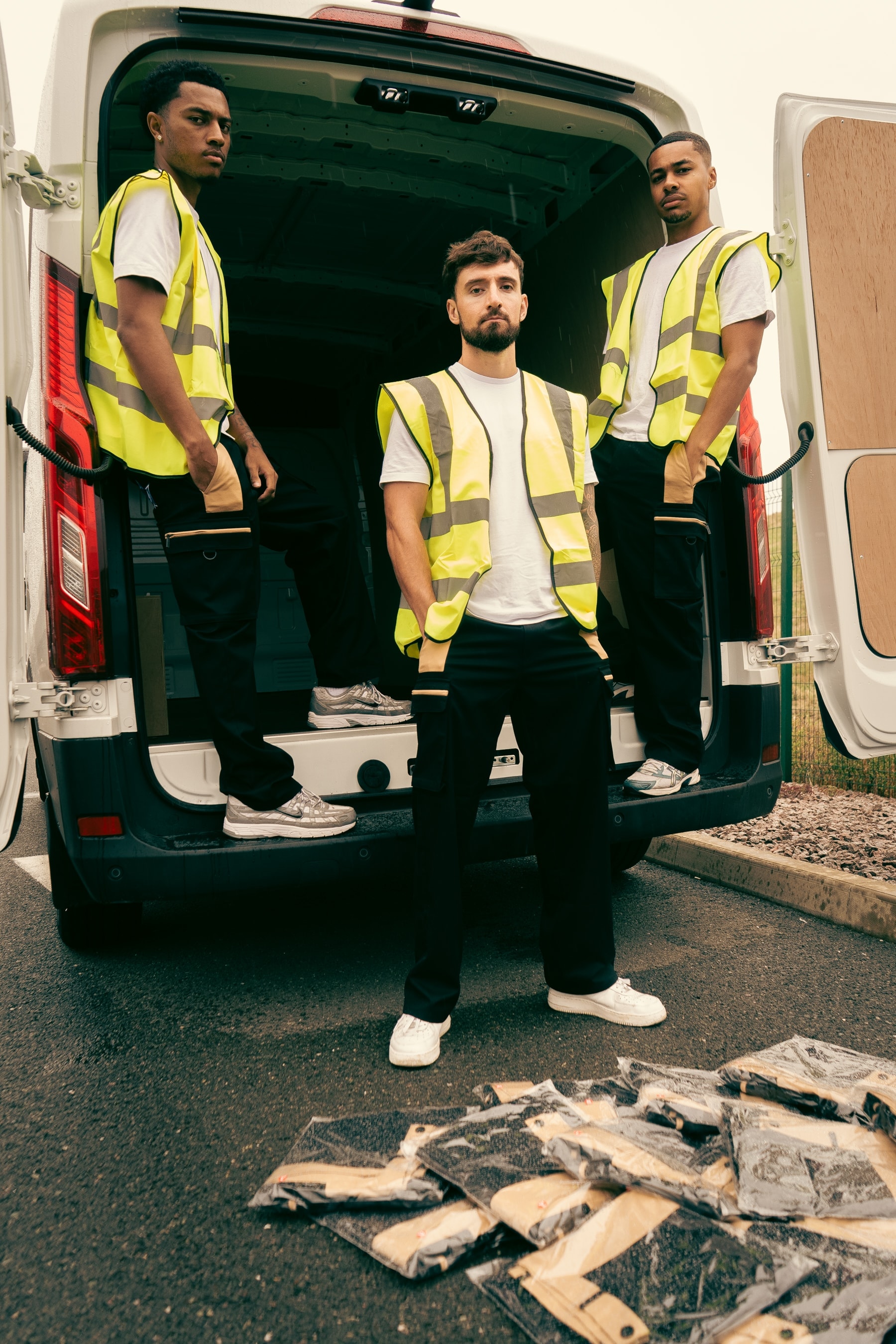 Three SELFMADE workers standing at the rear of the van with packaged orders